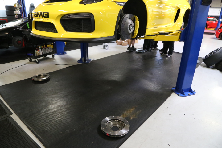 GMG's Cayman GT4 Brembo OE brakes being swapped out for Brembo Performance 2-piece disc upgrades.